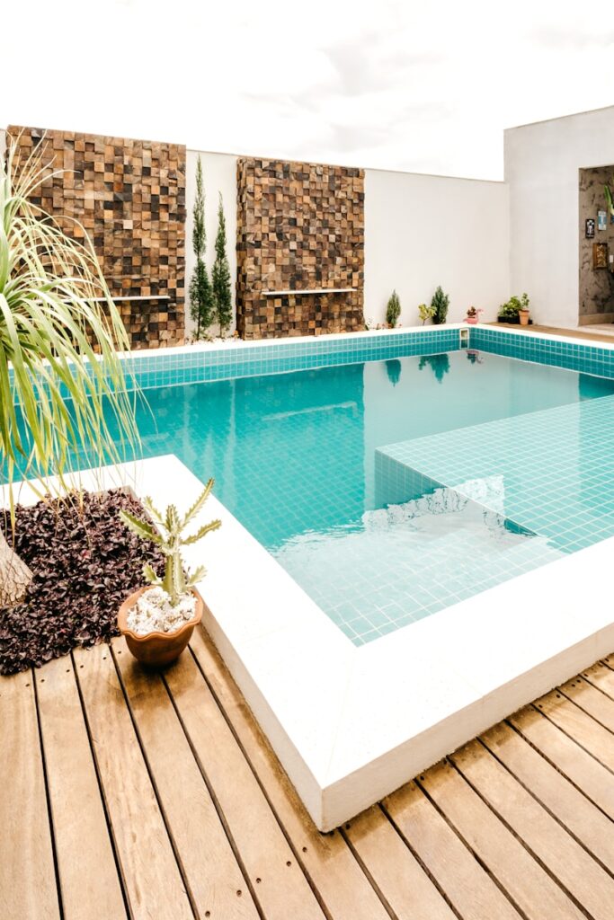 swimming pool near green trees during daytime